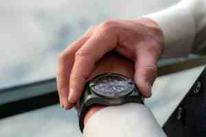 Close-up of a person wearing a watch during a business meeting.